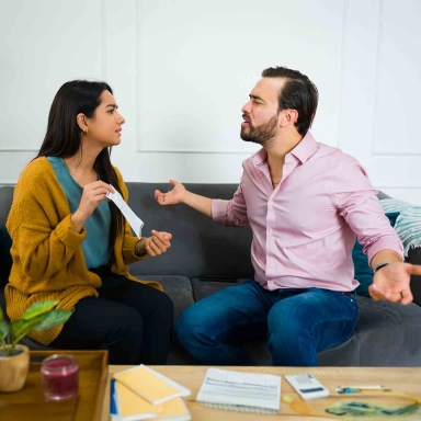 Angry married couple arguing about their finances